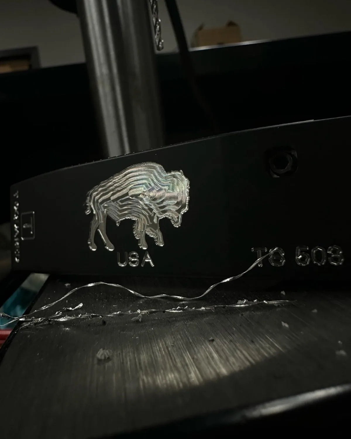 A buffalo being engraved into the sole of a TS-503